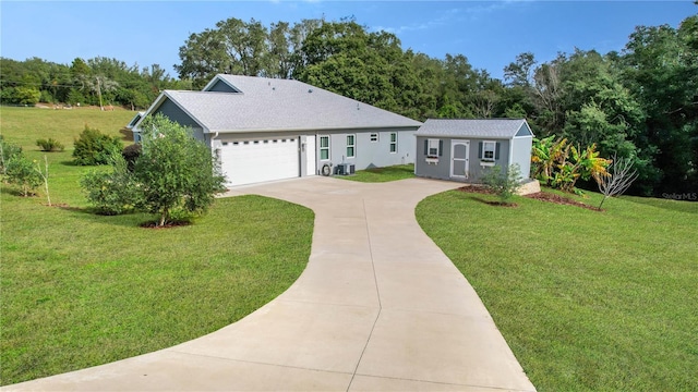 ranch-style home featuring a front yard, a garage, and a storage unit