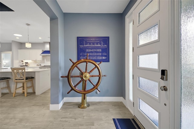 foyer entrance with light hardwood / wood-style flooring