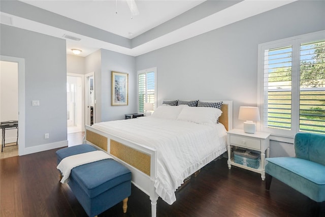 bedroom with ceiling fan and dark hardwood / wood-style flooring