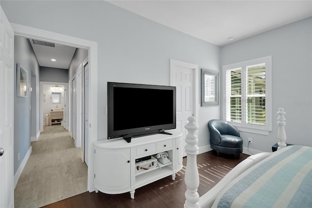 bedroom with dark hardwood / wood-style flooring