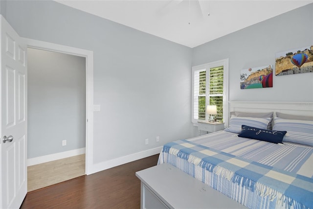 bedroom with ceiling fan and dark hardwood / wood-style flooring