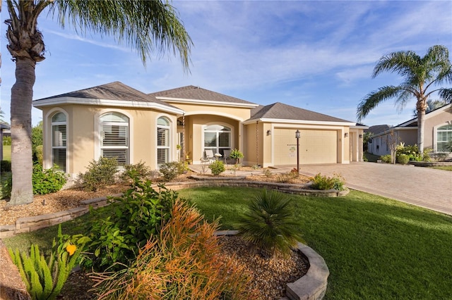 view of front of house with a garage and a front yard