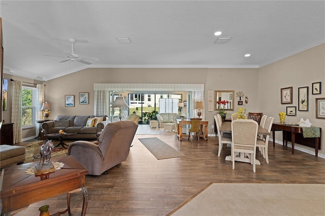 living room featuring a textured ceiling, crown molding, ceiling fan, and vaulted ceiling