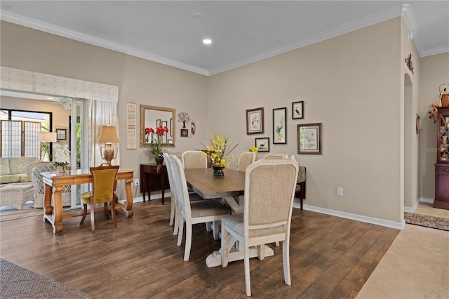 dining area featuring ornamental molding and dark wood-type flooring