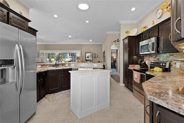 kitchen featuring sink, ornamental molding, light tile patterned flooring, kitchen peninsula, and stainless steel appliances