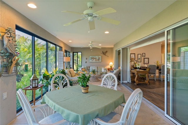 sunroom featuring ceiling fan