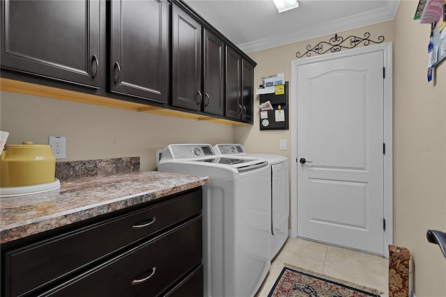 laundry area with cabinets, crown molding, separate washer and dryer, a textured ceiling, and light tile patterned floors