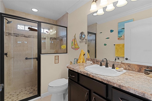 bathroom featuring crown molding, vanity, a shower with shower door, and toilet