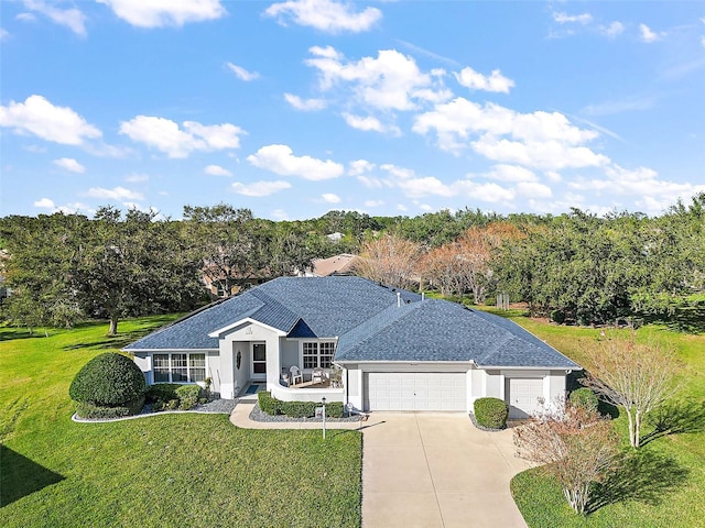 single story home featuring a front yard and a garage