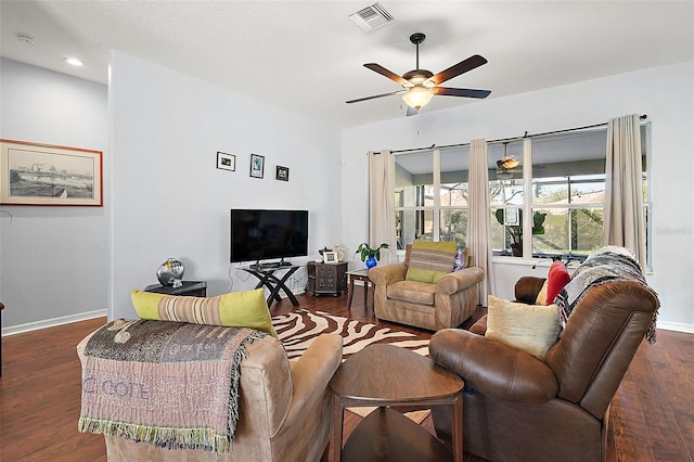 living room featuring ceiling fan and dark hardwood / wood-style flooring