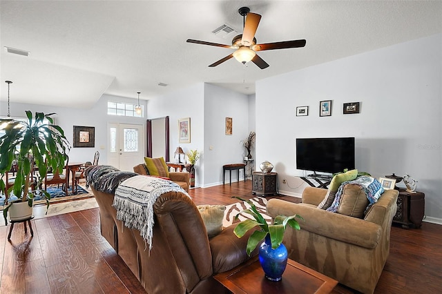 living room with ceiling fan and dark hardwood / wood-style floors