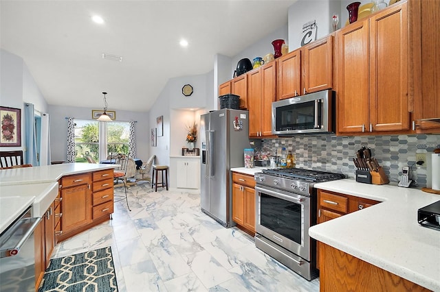 kitchen featuring backsplash, decorative light fixtures, lofted ceiling, and high end appliances