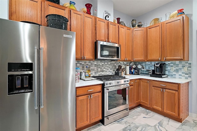 kitchen with appliances with stainless steel finishes and tasteful backsplash