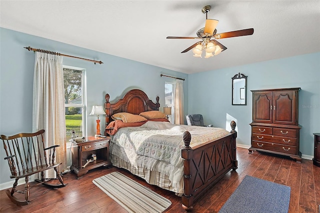 bedroom with multiple windows, ceiling fan, and dark wood-type flooring