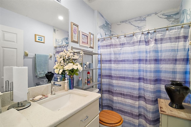 bathroom with a shower with shower curtain, vanity, and toilet