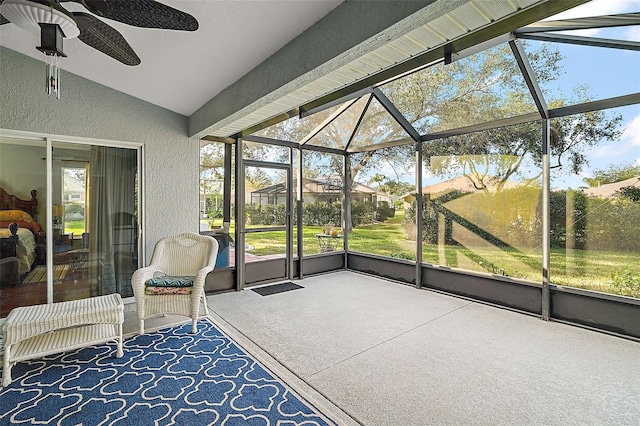 sunroom / solarium with ceiling fan and lofted ceiling