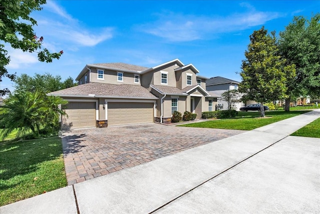 view of front facade with a front yard and a garage