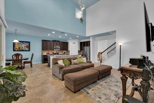 living room with a towering ceiling and sink