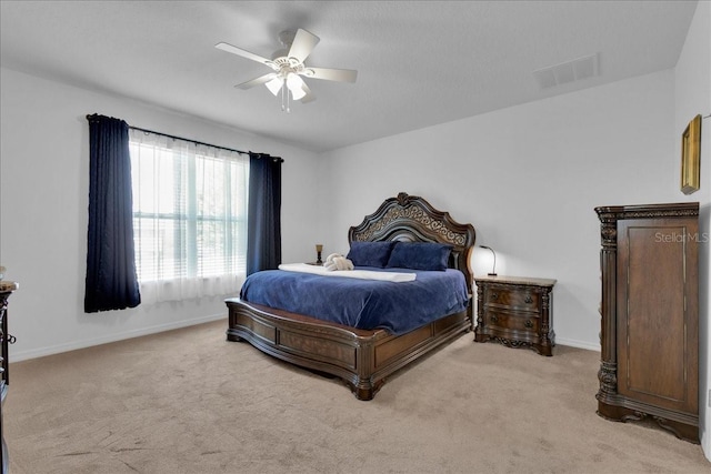 bedroom with ceiling fan and light carpet