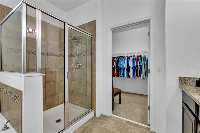 bathroom featuring vanity and an enclosed shower