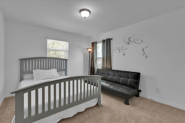 carpeted bedroom featuring a textured ceiling