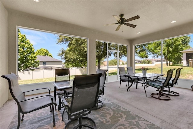 sunroom / solarium featuring ceiling fan