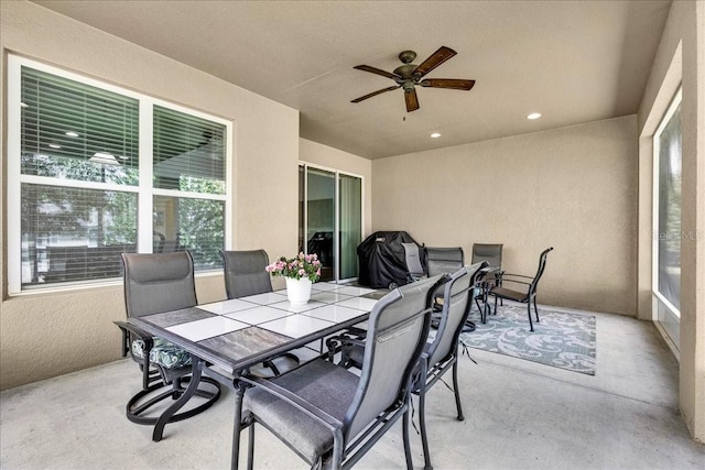 sunroom / solarium featuring ceiling fan