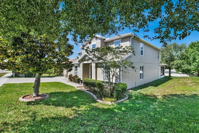9249 Ivywood St, Clermont, FL 34711 - view of front of house featuring stucco siding and a front lawn