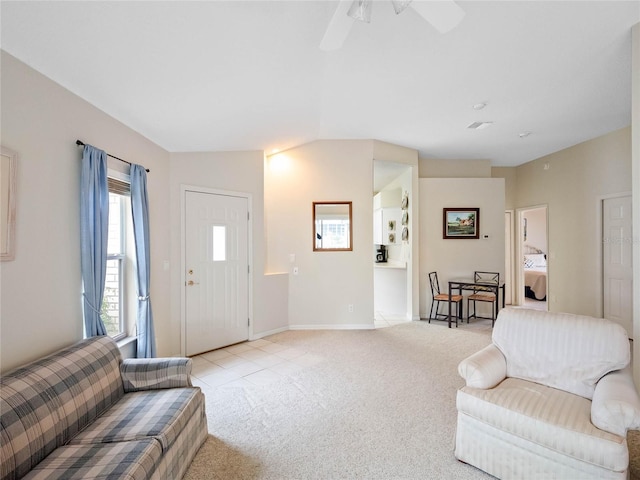 living room with vaulted ceiling, light colored carpet, and ceiling fan