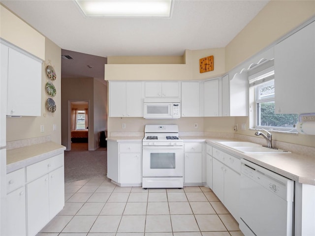 kitchen with sink, white cabinets, and white appliances