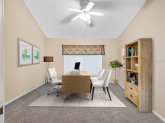 home office with lofted ceiling, a textured ceiling, ceiling fan, and carpet