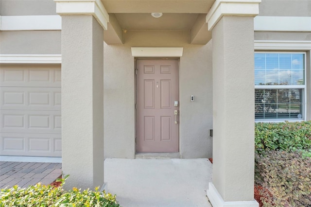 doorway to property with a garage