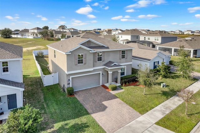 view of front of property with a garage and a front yard