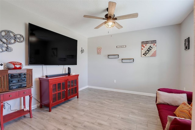 living area featuring ceiling fan and light wood-type flooring