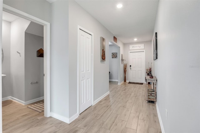 hall with light hardwood / wood-style flooring