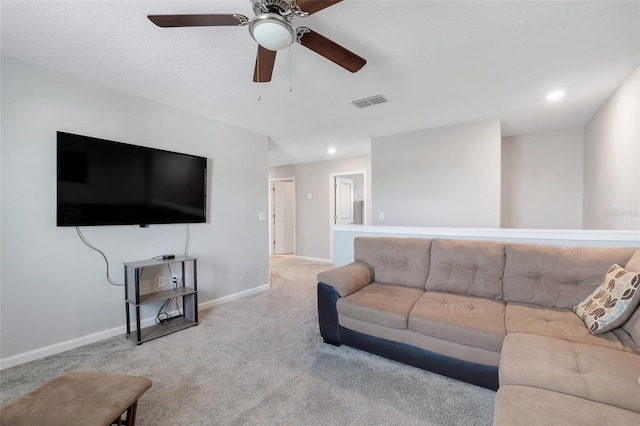 carpeted living room with ceiling fan