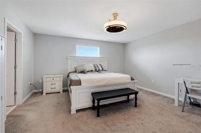 carpeted bedroom featuring a textured ceiling