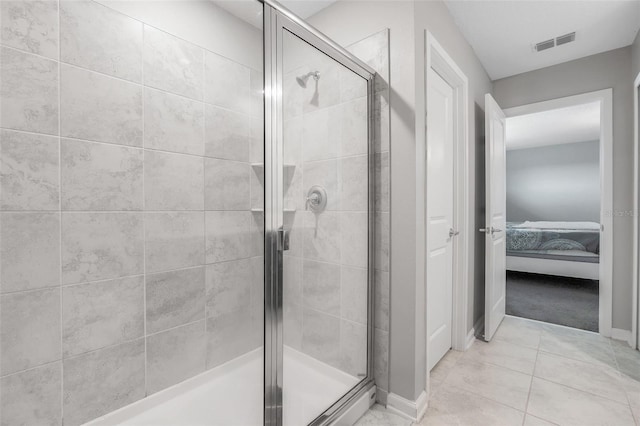 bathroom featuring tile patterned floors and a shower with shower door