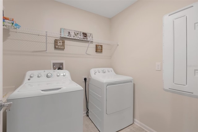 laundry room with light tile patterned floors and washing machine and dryer