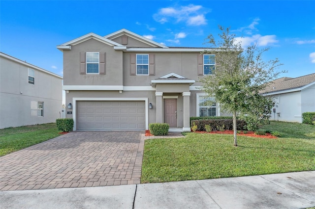 view of front of home featuring a garage and a front lawn