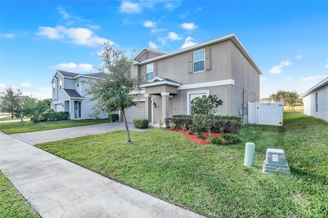 front of property with a front yard and a garage