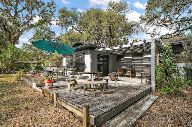 wooden deck with a pergola and a fire pit