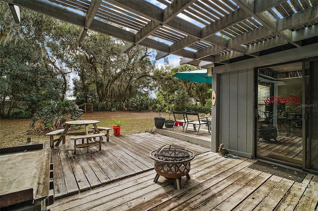 wooden terrace featuring a pergola and an outdoor fire pit