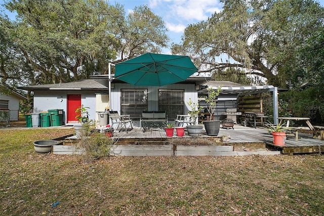 back of house with a wooden deck