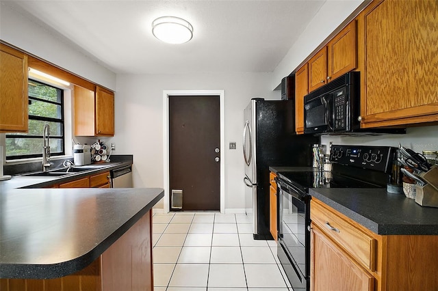 kitchen with kitchen peninsula, light tile patterned floors, sink, and black appliances