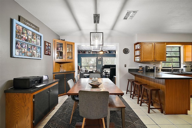 tiled dining area featuring sink