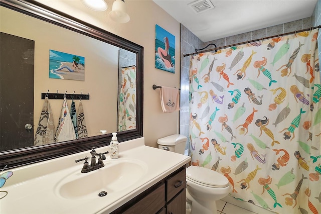 bathroom featuring tile patterned floors, a shower with curtain, vanity, and toilet