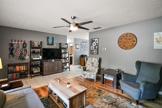 living room featuring ceiling fan and light tile patterned floors