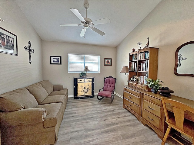 living room featuring ceiling fan, light wood-type flooring, and lofted ceiling