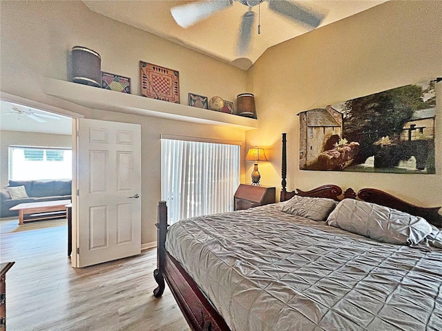 bedroom featuring ceiling fan, wood-type flooring, and lofted ceiling